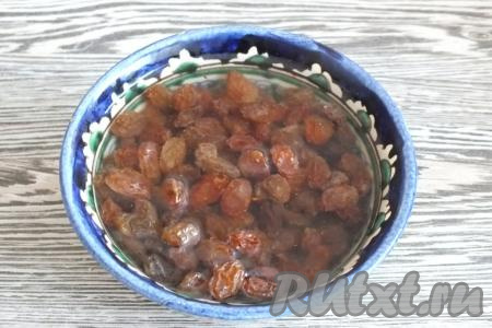 Приготовление булочек начните с подготовки изюма, тщательно промойте его и залейте кипятком на 10 минут, после воду слейте и оставьте просушиться.