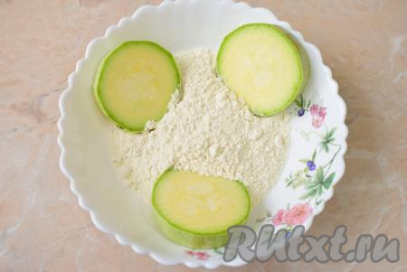 В достаточно глубокую тарелку насыпьте муку и обваляйте в ней все кружочки кабачков с двух сторон.