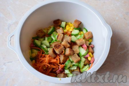 Непосредственно перед подачей в салат из корейской моркови, кукурузы, колбасы и свежего огурчика добавьте сухарики (если их добавить заранее, они размокнут и не будут приятно похрустывать в этом блюде).