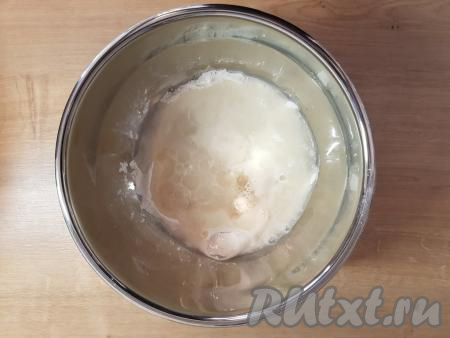 В получившуюся смесь влить подсолнечное масло.&nbsp;Далее начать постепенно добавлять воду комнатной температуры, каждый раз перемешивая венчиком до однородности.