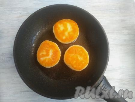 Подготовленные пышки выложить на сковороду, хорошо разогретую с растительным маслом, и жарить на среднем огне с двух сторон до зарумянивания (приблизительно, по 1,5 минуты с каждой стороны), затем накрыть крышкой сковороду, огонь уменьшить до минимума и готовить пышки ещё 2-3 минуты.