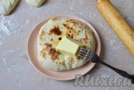 Готовую лепёшку переложите со сковороды на тарелку и сразу же смажьте кусочком сливочного масла. Таким же образом сформируйте и пожарьте все остальные лепёшки.