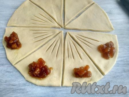 На каждом секторе выполнить надрезы, как на фото. На широкий край каждого сектора выложить по 1 чайной ложке густого варенья (или другой начинки).