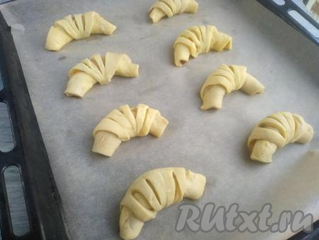 Сформированные рогалики выложить на некотором расстоянии друг от друга на противень, предварительно застеленный бумагой для выпечки. Выпекать рогалики минут 25-30 (до золотистости) в духовке, разогретой до 190 градусов.