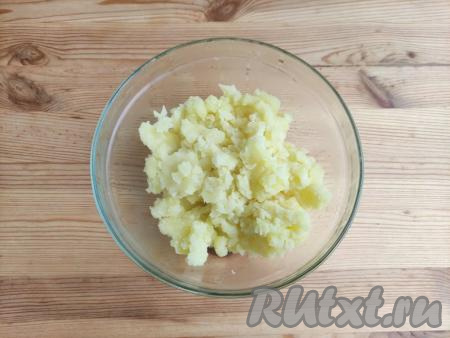 Тщательно слить воду из кастрюли, растолочь картофель с помощью толкушки.