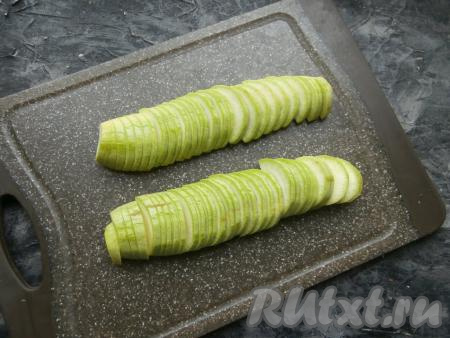 Кабачок нарезать достаточно тонкими полукружками (по 0,4-0,5 см толщиной). Если у кабачка тонкая кожица и мелкие семечки, можно готовить кабачки, не удаляя кожуру и семена.