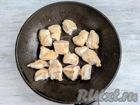 На сковороду налить растительное масло, обжарить курицу до зарумянивания со всех сторон на сильном огне, периодически помешивая.