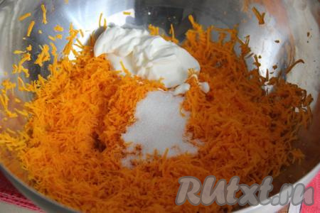 В миску с тыквой добавить сахар, сметану и 1 столовую ложку растительного масла, перемешать массу.