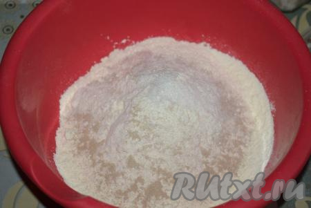 В достаточно объёмную миску насыпаем муку, сухие дрожжи, соль, сахар и тщательно перемешиваем мучную смесь ложкой.