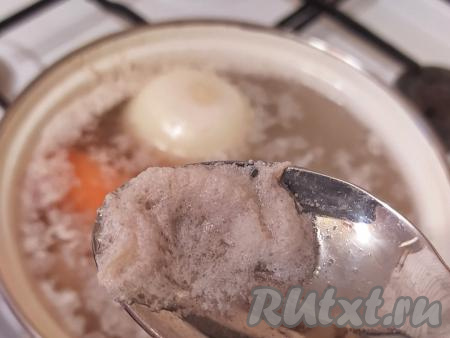 Когда вода начнёт кипеть, огонь нужно уменьшить до минимума (если не уменьшить огонь, из-за активного кипения бульон получится мутным). Аккуратно снять пену (пена - это тот самый свернувшийся от воздействия температуры белок). Если пену не убрать, бульон не будет прозрачным. Посолить воду, добавить горошинки душистого перца, очищенные луковицу и морковь. Я не добавляю в бульон больше никаких специй, чтобы не перебивать вкус.