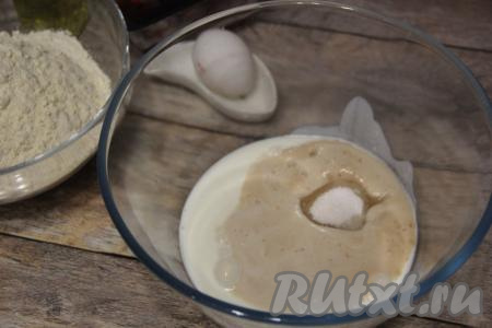 Воду, подогретую до 40 градусов, вылить в объёмную миску, добавить сухие дрожжи, тщательно перемешать и оставить в тёплом месте минут на 10. За это время дрожжевая смесь запенится. Кефир подогреть, примерно, до&nbsp;40 градусов (очень удобно подогревать его в микроволновке). Тёплый кефир влить в запенившуюся дрожжевую смесь, всыпать сахар и соль, перемешать венчиком.