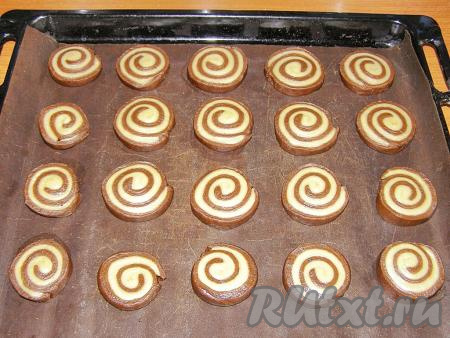 Нарезаем рулет на кружочки толщиной, примерно, 1 см и перекладываем их на противень, застеленный ковриком для выпечки (или пергаментной бумагой).