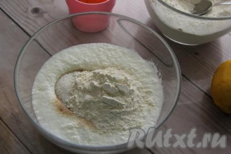 В миску влить тёплый кефир, всыпать сухие дрожжи и сахар, добавить 2 столовых ложки муки от общего объёма, перемешать получившуюся опару ложкой и оставить на 30 минут в тёплом месте.