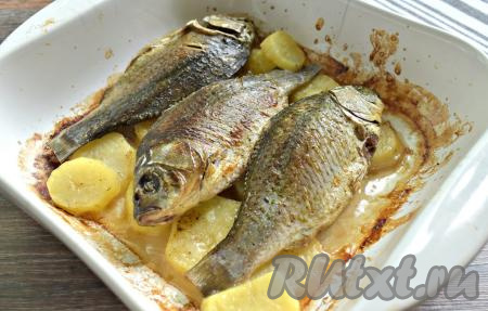 Помещаем форму с картошкой и карасями в разогретую до 180 градусов духовку на 30 минут. Затем фольгу убираем и запекаем ещё 10 минут.