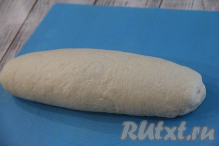 Скатать тесто в плотный рулет, начиная с широкой стороны. Края заготовки хлеба хорошо защипнуть.
