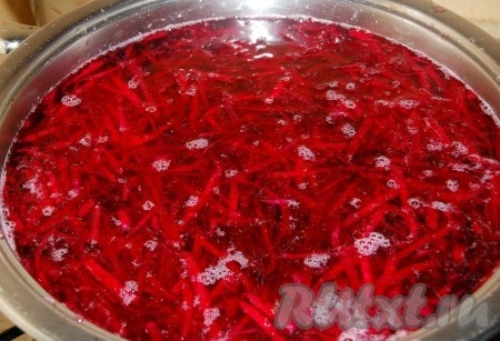 Натертую свеклу положить в большую кастрюлю, залить холодной водой и поставить вариться.