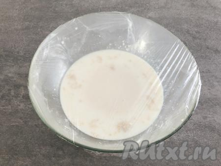 Смешиваем 150 миллилитров молока со 150 миллилитрами воды, подогреваем примерно до 40 градусов и переливаем в объёмную миску, насыпаем сахар, ванильный сахар, добавляем сухие дрожжи и хорошенько перемешиваем лопаткой (или ложкой). Миску накрываем плёнкой (или полотенцем) и ставим в тёплое место минут на 10-15 для того, чтобы дрожжи активизировались.