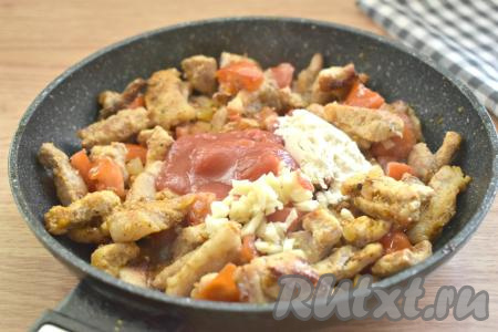 Затем на сковороду всыпаем муку, добавляем томатную пасту, мелко нарезанные зубчики чеснока, перемешиваем.