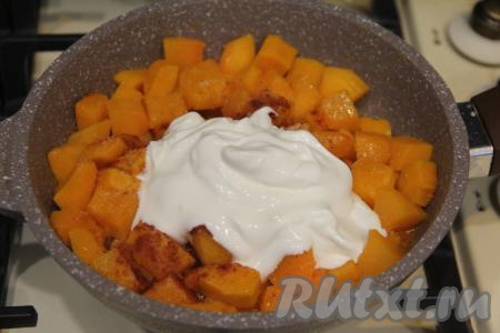 Затем в сковороду с тыквой и чесноком выложить сметану.