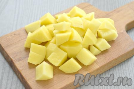 После того как горох станет достаточно мягким, выкладываем в кастрюлю очищенный картофель, нарезанный на кубики, даём закипеть, уменьшаем огонь и варим гороховый суп с копчёными рёбрышками минут 20 (картошка должна стать достаточно мягкой).