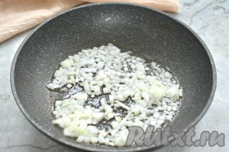 Покупное слоёное тесто достаём из морозилки и оставляем его размораживаться при комнатной температуре. Пока тесто размораживается, можно заняться начинкой. Очищенную луковицу нарезаем на небольшие кубики, выкладываем в сковороду с разогревшимся растительным маслом и обжариваем на среднем огне, иногда помешивая, в течение 3-4 минут (до мягкости лука).