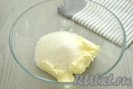 Сливочное масло, согревшееся до комнатной температуры, выкладываем в глубокую миску, всыпаем сахар, перетираем получившуюся смесь до однородности венчиком (или миксером).