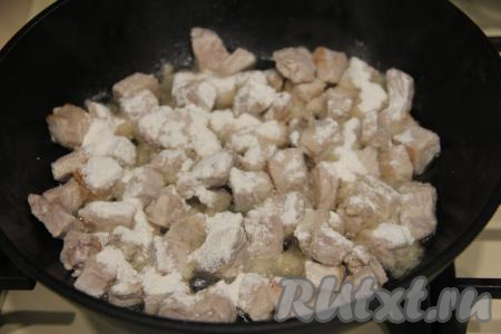 К обжаренному мясу всыпать муку, перемешать.