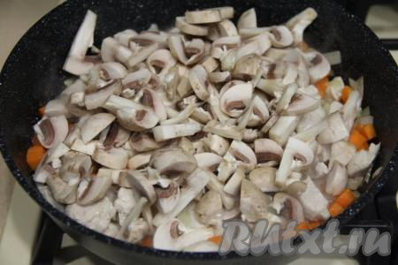 Шампиньоны нарезать на пластинки. Добавить грибы в сковороду, перемешать.