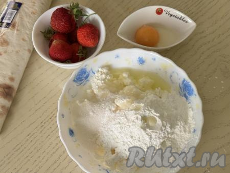 Яйцо разделить на белок и желток. Белок будем использовать в начинке, желток - для смазывания рулета. В глубокой тарелке соединить творог, яичный белок, крахмал и сахар. Благодаря крахмалу творожно-ягодная начинка не будет вытекать в процессе выпечки рулета в духовке.