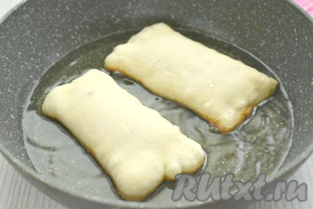 В сковороде хорошо разогреваем&nbsp;растительное масло. Выкладываем в горячее масло пирожки "швом" вниз. Масло должно доходить до середины пирожков. Жарим пирожки с яблоками до подрумянивания слоёного теста с двух сторон (ориентировочно по 2,5 минуты с каждой стороны).