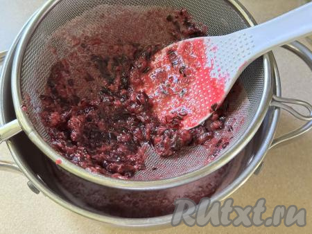 Затем взять небольшую кастрюлю с толстым дном, поверх неё поставить сито. Выложить в сито ягодную массу и перетереть с помощью лопатки (или столовой ложки) в кастрюлю. В результате перетирания ягодной массы в сите останется совсем немного жмыха, который нам не понадобится.