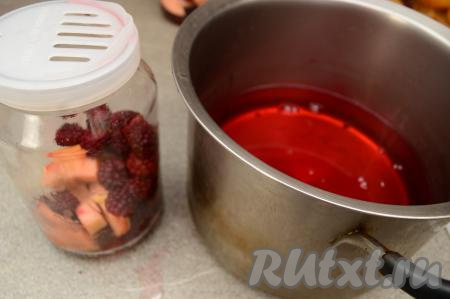 Затем воду из банок слить в кастрюлю, стараясь, чтобы ежевика и яблоки остались в банке. Удобно сливать воду, надев на банку капроновую крышку с дырочками.