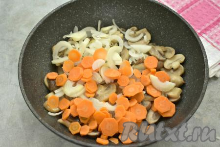 К обжаренным шампиньонам выкладываем нарезанные лук и морковь, перемешиваем. Обжариваем минут 7-8 (до мягкости морковки и лука), не забывая время от времени перемешивать.&nbsp;&nbsp;