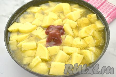 Содержимое сковороды полностью заливаем водой, добавляем томатный соус, перемешиваем.