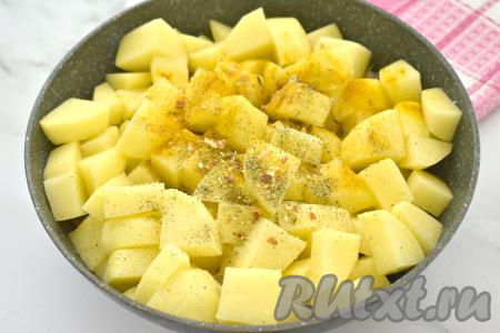 К капусте, обжаренной с индейкой, добавляем картофель, нарезанный на средние кубики, по вкусу солим, приправляем специями.