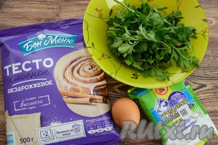 Подготовить продукты для приготовления пирога с творогом и зеленью из слоёного теста. Зелень можно взять любую - петрушку, кинзу, укроп, базилик, зелёный лук, а лучше смешать несколько видов зелени. Я взяла петрушку. Слоёное тесто подойдёт любое (дрожжевое или бездрожжевое), его нужно достать из морозилки и оставить размораживаться при комнатной температуре. Творог можно взять любой жирности, у меня - жирностью 5%.