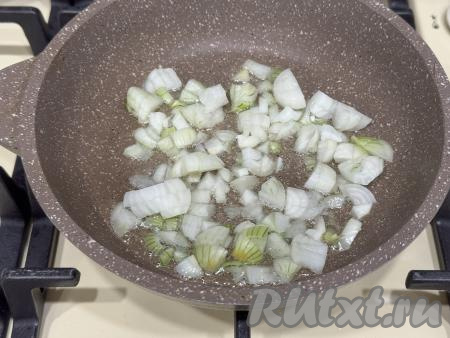 Лук почистить, мелко нарезать. В сковороду влить растительное масло, разогреть, затем уменьшить огонь до среднего, выложить лук.