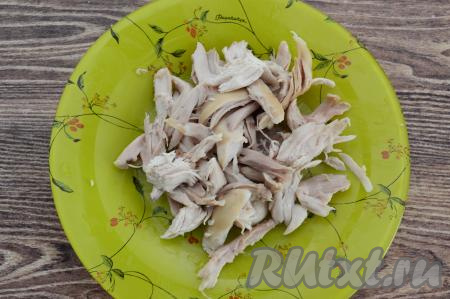 Сварившиеся кусочки курицы достать из бульона, дать немного остыть. Отделить мясо от костей. Бульон, если необходимо, процедить, затем вернуть в кастрюлю. Поставить кастрюлю с бульоном на огонь, довести до кипения.