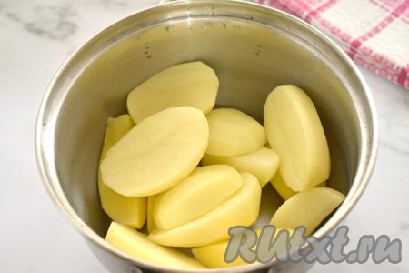 Пока варится мясо, в другую кастрюлю выкладываем&nbsp;очищенный и нарезанный на части картофель, заливаем полностью водой, ставим на огонь, а после закипания, добавив соль и уменьшив огонь, отвариваем до готовности (на варку потребуется минут 25 с момента закипания воды, готовые картошины должны легко прокалываться вилкой). После того как картошка сварится, сливаем большую часть воды, в которой готовился картофель, оставляя в кастрюле миллилитров 70 воды.