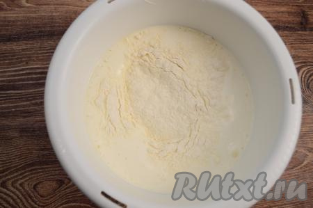 Затем всыпать весь разрыхлитель и 100 грамм просеянной муки, тщательно вмешать её движениями лопатки (или столовой ложки) снизу-вверх, как бы складывая тесто от краёв чаши к середине. Затем добавлять оставшуюся просеянную муку небольшими порциями, каждый раз полностью вмешивая муку в бисквитное тесто, стараясь не сбить воздушность взбитых яиц.
