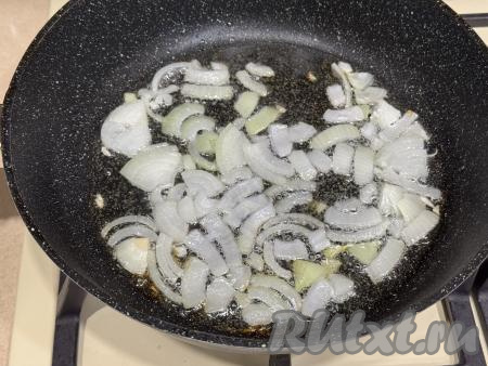 Лук и чеснок очистить. В сковороду влить растительное масло, разогреть, выложить лук, нарезанный на четверть кольца, обжарить до прозрачности (минуты 3-4), время от времени помешивая, на среднем огне.&nbsp;