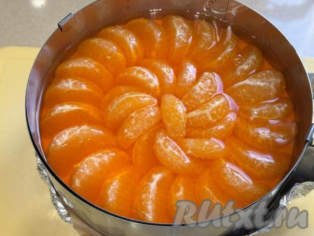 Залить все дольки мандарина остывшим желе и поставить в холодильник на ночь (до полного застывания мандаринового слоя чизкейка).&nbsp;