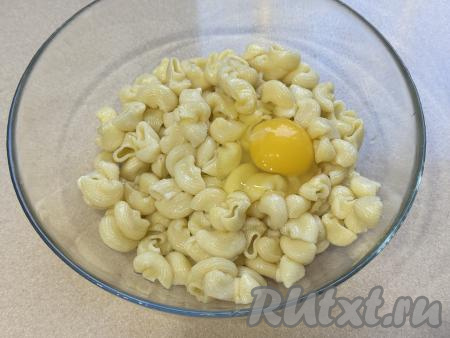 Остывшие макароны выложить в глубокую миску, добавить сырое яйцо, перемешать до однородности. Если нужно, подсолить.