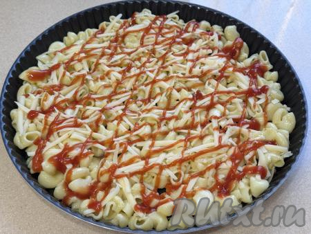 Поверх макарон, посыпанных сыром, нанести решётку из томатного соуса (или кетчупа).&nbsp;
