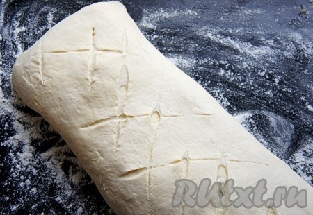Тесто раскатать толщиной 3 мм, выложить начинку на один край, затем, подогнув края справа и слева, сворачиваем  широким рулетом - получается сформированный штрудель. Противень "припылить" мукой и выложить штрудель. Сделать небольшие надрезы.