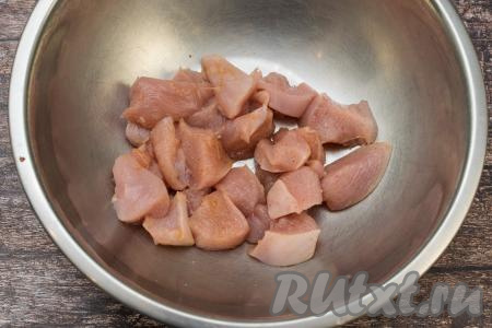 Сложить нарезанное куриное мясо в миску, посолить, добавить любимые специи для птицы, тщательно перемешать.