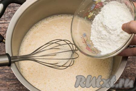Небольшими порциями добавить в кастрюлю крахмал, непрерывно перемешивая желтково-молочную смесь венчиком.