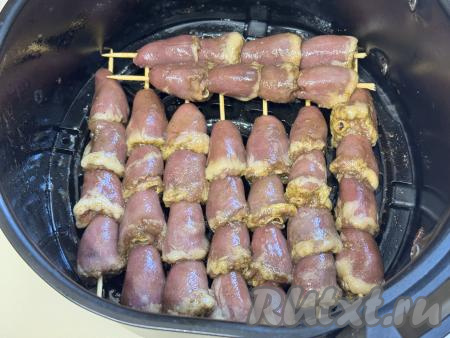 Куриные сердечки на шпажках выложить на решётку аэрогриля в один слой. Выставить температуру 200 градусов и время - 20 минут. Отправить чашу в аэрогриль.