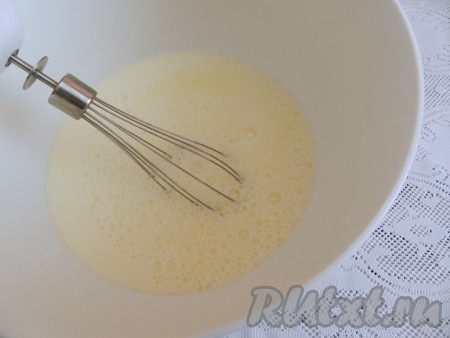 Влить молоко, взбить венчиком до однородности. Добавить соду, погашенную 1 столовой ложкой кипящей воды, перемешать.