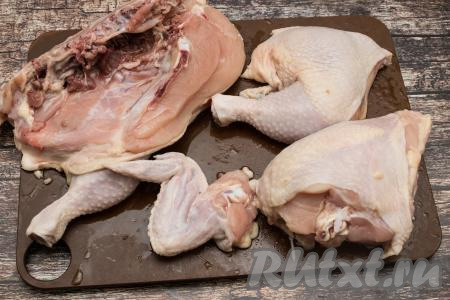 Курицу промыть водой. По грудине разрезать птицу на 2 равных половины. Вначале одну половину курочки разрезать на несколько частей, чтобы получились крыло, окорочок и куриная грудка.